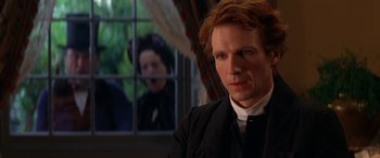 Movie still from “Oscar and Lucinda” (1997), directed by Gillian Armstrong – A man and a woman in front of an open window; Close Up shot, Over the shoulder angle