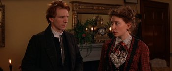 Movie still from “Oscar and Lucinda” (1997), directed by Gillian Armstrong – A man and a woman standing next to each other in front of a fireplace; Close Up shot, Over the shoulder angle