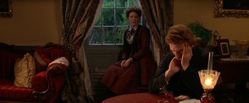 Movie still from “Oscar and Lucinda” (1997), directed by Gillian Armstrong – A woman sitting on a chair in front of a window; Medium shot, High angle