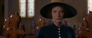 Movie still from “Oscar and Lucinda” (1997), directed by Gillian Armstrong – A woman wearing a hat in a room with stained glass windows; Close Up shot, Low angle