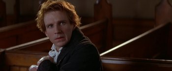 Movie still from “Oscar and Lucinda” (1997), directed by Gillian Armstrong – A person sitting in front of a window; Close Up shot, Over the shoulder angle