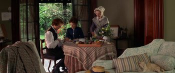 Movie still from “Oscar and Lucinda” (1997), directed by Gillian Armstrong – Three people sitting at a table with food on it; Wide shot, High angle