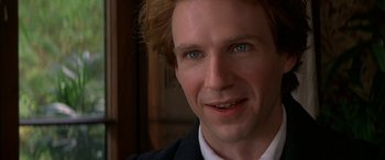 Movie still from “Oscar and Lucinda” (1997), directed by Gillian Armstrong – A man's face in a suit and tie; Close Up shot, Over the shoulder angle