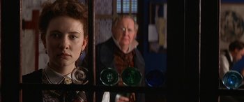 Movie still from “Oscar and Lucinda” (1997), directed by Gillian Armstrong – A woman and an older man are reflected in a mirror; Close Up shot, Over the shoulder angle