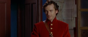 Movie still from “Oscar and Lucinda” (1997), directed by Gillian Armstrong – A man in a red jacket is standing in front of a door; Close Up shot, Over the shoulder angle
