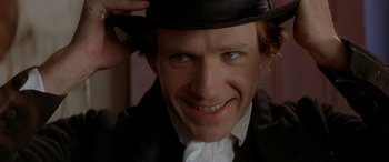 Movie still from “Oscar and Lucinda” (1997), directed by Gillian Armstrong – A person wearing a hat; Close Up shot, Over the shoulder angle