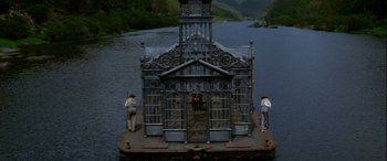 Movie still from “Oscar and Lucinda” (1997), directed by Gillian Armstrong – Three people standing on a boat in the middle of a lake; Extreme Wide shot, High angle