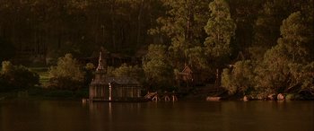 Movie still from “Oscar and Lucinda” (1997), directed by Gillian Armstrong – A lake with a small house on the water; Extreme Wide shot, High angle