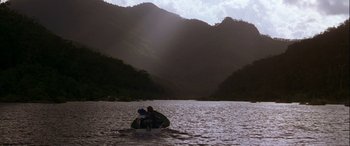 Movie still from “Oscar and Lucinda” (1997), directed by Gillian Armstrong – A man is sitting on a boat in the water; Extreme Wide shot, Low angle
