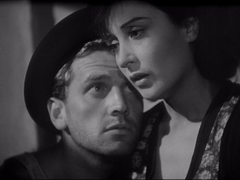 Movie still from “Obsession” (1943), directed by Luchino Visconti – A man and a woman looking at each other; Close Up shot, High angle