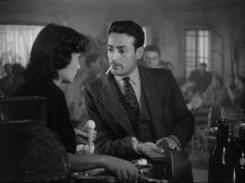 Movie still from “Obsession” (1943), directed by Luchino Visconti – A man and a woman are talking to each other; Medium shot, Over the shoulder angle