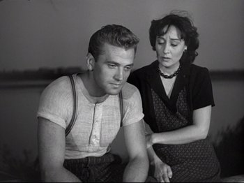 Movie still from “Obsession” (1943), directed by Luchino Visconti – A man and a woman sitting next to each other; Medium shot, Low angle