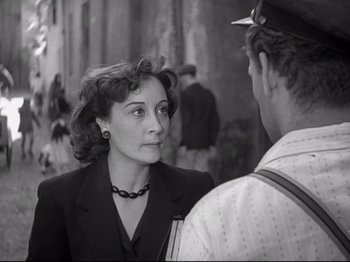 Movie still from “Obsession” (1943), directed by Luchino Visconti – An old photo of a woman talking to a man; Close Up shot, Over the shoulder angle