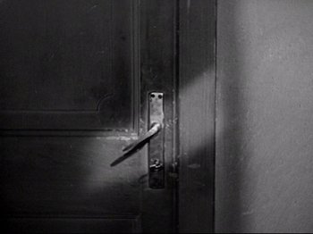 Movie still from “Obsession” (1943), directed by Luchino Visconti – A black and white photo of a door handle; Extreme Close Up shot, High angle