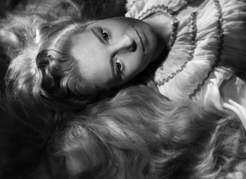 Movie still from “Othello” (1951), directed by Orson Welles – A woman with long hair laying on the ground; Close Up shot, High angle