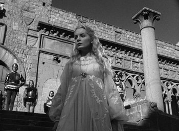Movie still from “Othello” (1951), directed by Orson Welles – Black and white photograph of a woman in medieval dress; Medium shot, Low angle