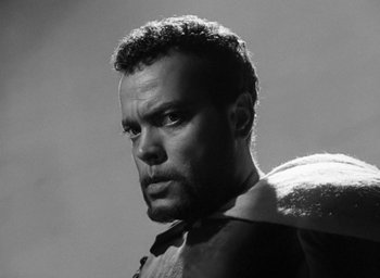 Movie still from “Othello” (1951), directed by Orson Welles – Black and white photograph of a man with a beard; Close Up shot, Low angle