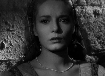 Movie still from “Othello” (1951), directed by Orson Welles – Black and white photograph of a woman with a necklace; Close Up shot, Low angle