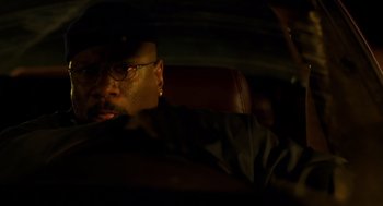 Movie still from “Out of Sight” (1998), directed by Steven Soderbergh – A man sitting in the back seat of a car at night; Close Up shot, Low angle