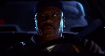 Movie still from “Out of Sight” (1998), directed by Steven Soderbergh – A person driving a car at night; Close Up shot, Low angle