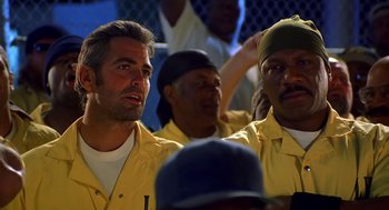 Movie still from “Out of Sight” (1998), directed by Steven Soderbergh – A group of men sitting next to each other; Close Up shot, Low angle