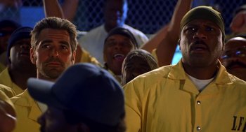 Movie still from “Out of Sight” (1998), directed by Steven Soderbergh – A group of men sitting next to each other; Close Up shot, Low angle