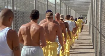 Movie still from “Out of Sight” (1998), directed by Steven Soderbergh – A group of men walking down a sidewalk; Wide shot, High angle