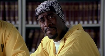 Movie still from “Out of Sight” (1998), directed by Steven Soderbergh – A person wearing a hat; Close Up shot, Low angle