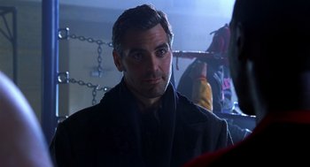 Movie still from “Out of Sight” (1998), directed by Steven Soderbergh – A person wearing a coat; Close Up shot, Over the shoulder angle