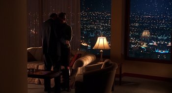 Movie still from “Out of Sight” (1998), directed by Steven Soderbergh – Two people standing in front of a window at night; Wide shot, High angle