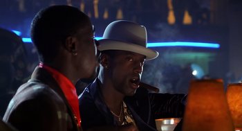 Movie still from “Out of Sight” (1998), directed by Steven Soderbergh – Two men sitting at a table with a cigar in their mouth; Close Up shot, Low angle