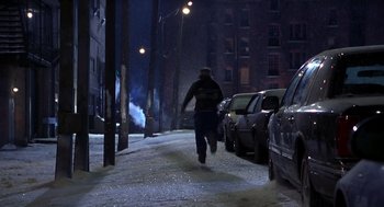 Movie still from “Out of Sight” (1998), directed by Steven Soderbergh – A man walking down a street at night; Wide shot, High angle