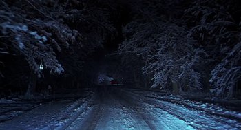 Movie still from “Out of Sight” (1998), directed by Steven Soderbergh – A car driving down a snowy road at night; Extreme Wide shot, Low angle