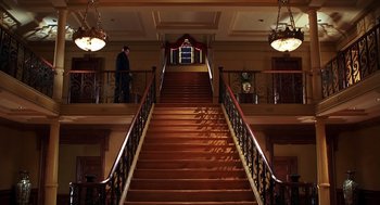 Movie still from “Out of Sight” (1998), directed by Steven Soderbergh – A man standing on the bottom of a set of stairs; Extreme Wide shot, Low angle