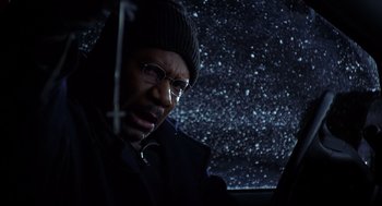 Movie still from “Out of Sight” (1998), directed by Steven Soderbergh – A man with glasses and a hat in the dark; Close Up shot, Low angle