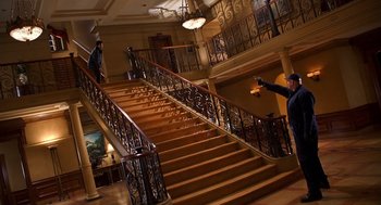 Movie still from “Out of Sight” (1998), directed by Steven Soderbergh – Two people walking down a staircase in a building; Wide shot, Low angle