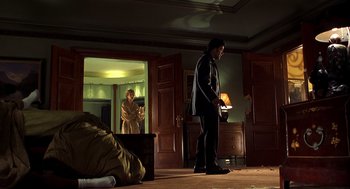 Movie still from “Out of Sight” (1998), directed by Steven Soderbergh – A man and a woman standing in a living room; Wide shot, Low angle