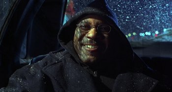 Movie still from “Out of Sight” (1998), directed by Steven Soderbergh – A man wearing glasses and a hooded jacket; Close Up shot, Low angle