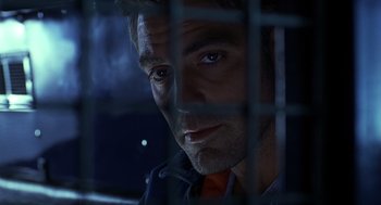 Movie still from “Out of Sight” (1998), directed by Steven Soderbergh – A person behind a fence; Close Up shot, Low angle