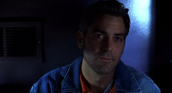 Movie still from “Out of Sight” (1998), directed by Steven Soderbergh – A person wearing a jean jacket; Close Up shot, Low angle