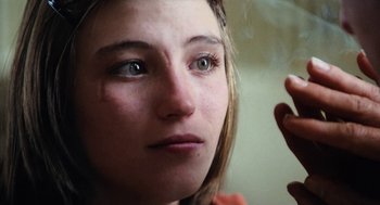 Movie still from “Out of the Blue” (1980), directed by Dennis Hopper – A woman's eyes and face; Close Up shot, Over the shoulder angle