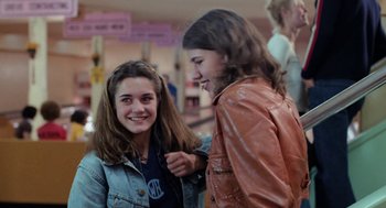 Movie still from “Out of the Blue” (1980), directed by Dennis Hopper – Two young girls are talking to each other; Medium shot, Low angle