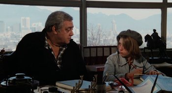 Movie still from “Out of the Blue” (1980), directed by Dennis Hopper – A man and a woman sitting in front of a window; Medium shot, Over the shoulder angle