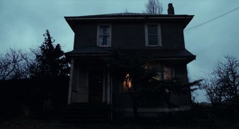 Movie still from “Out of the Blue” (1980), directed by Dennis Hopper – An image of an old house at night time; Extreme Wide shot, Low angle