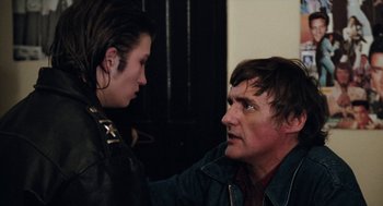 Movie still from “Out of the Blue” (1980), directed by Dennis Hopper – A man and a woman talking to each other; Close Up shot, Over the shoulder angle