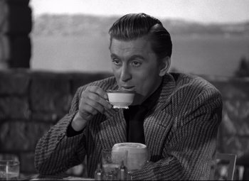 Movie still from “Out of the Past” (1947), directed by Jacques Tourneur – A black and white photo of a man drinking a cup; Medium shot, High angle