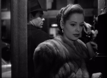 Movie still from “Out of the Past” (1947), directed by Jacques Tourneur – A man and a woman in a fur coat; Close Up shot, High angle