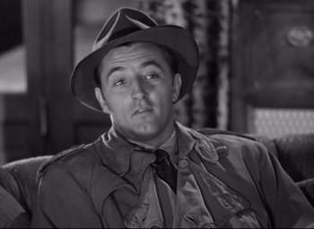 Movie still from “Out of the Past” (1947), directed by Jacques Tourneur – A man wearing a hat and a jacket; Close Up shot, High angle