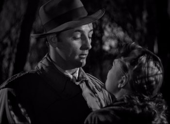 Movie still from “Out of the Past” (1947), directed by Jacques Tourneur – A man and a little girl in the dark; Close Up shot, Over the shoulder angle