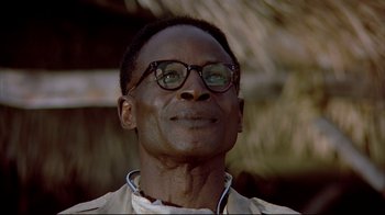 Movie still from “Outbreak” (1995), directed by Wolfgang Petersen – A person wearing glasses looking up; Close Up shot, Low angle